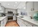 Modern kitchen with white shaker cabinets, quartz countertops, and stainless steel appliances at 2519 Crowder Ln, Tampa, FL 33629