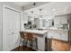 Modern kitchen with white shaker cabinets, quartz countertops, and breakfast bar at 2519 Crowder Ln, Tampa, FL 33629