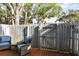 Brick patio with gray fence, gate, and wicker chairs at 2519 Crowder Ln, Tampa, FL 33629