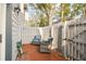 Brick patio with gray fence, gate, and wicker chairs at 2519 Crowder Ln, Tampa, FL 33629