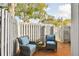 Brick patio with gray fence, gate, and wicker chairs at 2519 Crowder Ln, Tampa, FL 33629