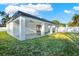 Covered patio and grassy backyard with white fence at 2905 W Collins St, Tampa, FL 33607