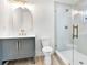 Modern bathroom with gray vanity, gold fixtures, and a glass shower at 2905 W Collins St, Tampa, FL 33607