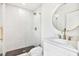 Clean bathroom with white vanity, gold fixtures, and geometric tile at 2905 W Collins St, Tampa, FL 33607