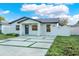 Modern house with a gray roof and landscaped yard at 2905 W Collins St, Tampa, FL 33607