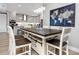 Bright dining room featuring a large farmhouse table and modern light fixtures at 300 150Th Ave # 502, Madeira Beach, FL 33708