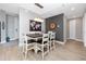 Bright dining room with rustic table and modern light fixture at 300 150Th Ave # 502, Madeira Beach, FL 33708