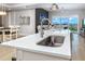 Modern kitchen island with sink and stainless steel appliances at 300 150Th Ave # 502, Madeira Beach, FL 33708