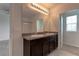 Double vanity bathroom with granite countertop and mirror at 30755 Summer Sun Loop, Wesley Chapel, FL 33545