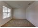 Simple bedroom with carpeted flooring and a large window at 30755 Summer Sun Loop, Wesley Chapel, FL 33545