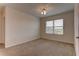 Well-lit bedroom with window, carpet, and neutral walls at 30755 Summer Sun Loop, Wesley Chapel, FL 33545