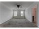 Bedroom with ceiling fan, carpet, and two windows at 30755 Summer Sun Loop, Wesley Chapel, FL 33545