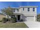 Two-story house with a two-car garage and landscaped front yard at 30755 Summer Sun Loop, Wesley Chapel, FL 33545