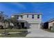 Two-story house with a two-car garage and a well-manicured lawn at 30755 Summer Sun Loop, Wesley Chapel, FL 33545