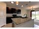 Modern kitchen with island and stainless steel appliances at 30755 Summer Sun Loop, Wesley Chapel, FL 33545