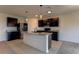 Modern kitchen with dark cabinets and granite countertops at 30755 Summer Sun Loop, Wesley Chapel, FL 33545