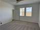 Bright bedroom featuring neutral carpet, ceiling fan, and large window at 31819 Cardinal Yard Dr, San Antonio, FL 33576