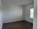 Empty room showcasing dark tile floors, white walls, and natural light at 31819 Cardinal Yard Dr, San Antonio, FL 33576