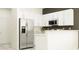 Modern kitchen with stainless steel appliances and white cabinetry at 32058 Spiceberry St, San Antonio, FL 33576