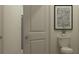 Clean and modern bathroom with a toilet and decorative artwork at 32178 Jamaica Caper Way, San Antonio, FL 33576