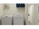 Bright laundry room with washer, dryer, and ample shelving at 32178 Jamaica Caper Way, San Antonio, FL 33576