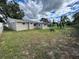 Large backyard with grassy area and home view at 3341 Wiltshire Dr, Holiday, FL 34691