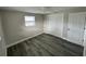 Simple bedroom with gray flooring and double door closet at 3341 Wiltshire Dr, Holiday, FL 34691