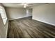 Open living room with hardwood-style flooring and ceiling fan at 3341 Wiltshire Dr, Holiday, FL 34691