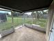 Screened porch overlooking backyard with grassy area at 3341 Wiltshire Dr, Holiday, FL 34691