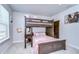 Spacious bedroom with a bunk bed, window, and plush bedding at 35474 Quartz Lake Dr, Zephyrhills, FL 33541