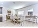 Bright dining room features a rustic wooden table with six upholstered chairs at 35474 Quartz Lake Dr, Zephyrhills, FL 33541