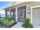 Attractive front entrance with screened door and landscaping at 35474 Quartz Lake Dr, Zephyrhills, FL 33541