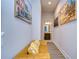 Long hallway with a comfy sofa and beach-themed artwork at 35474 Quartz Lake Dr, Zephyrhills, FL 33541