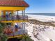 Two-story balcony overlooking the beach with outdoor furniture at 3702 El Centro St, St Pete Beach, FL 33706