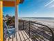 Balcony with a blue chair overlooking a beautiful beach view at 3702 El Centro St, St Pete Beach, FL 33706