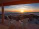 Breathtaking sunset ocean view from a private balcony with comfortable seating, perfect for relaxing at 3702 El Centro St, St Pete Beach, FL 33706