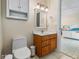 Bathroom with cherry wood cabinets, white countertops, and decorative star pulls at 3702 El Centro St, St Pete Beach, FL 33706