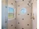 Shower showcasing octagonal window and tiled walls at 3702 El Centro St, St Pete Beach, FL 33706