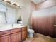 Well-lit bathroom with double sinks, a large mirror, and a tiled shower at 3702 El Centro St, St Pete Beach, FL 33706