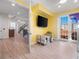 View of bedroom through doorway with TV, toys, and balcony door at 3702 El Centro St, St Pete Beach, FL 33706