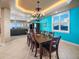 Well-lit dining room boasts a large wood table with seating for ten, chandelier, and stunning ocean views at 3702 El Centro St, St Pete Beach, FL 33706