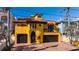 A two-story yellow house with a double garage at 3702 El Centro St, St Pete Beach, FL 33706