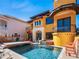 Striking yellow home with a pool, spa, and terracotta tile roof at 3702 El Centro St, St Pete Beach, FL 33706