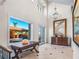 Grand foyer with a high ceiling, tiled floors, chandelier, and a view to the pool area at 3702 El Centro St, St Pete Beach, FL 33706