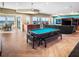 Open-concept game room features a billiards table, bar area, and stunning ocean views through sliding glass doors at 3702 El Centro St, St Pete Beach, FL 33706