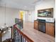 Hallway with wood floors, ornate railings, wet bar and adjacent artwork at 3702 El Centro St, St Pete Beach, FL 33706