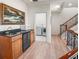 Hallway with wet bar leading to laundry room and staircase at 3702 El Centro St, St Pete Beach, FL 33706