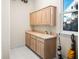 Bright laundry room features ample counter space, built-in cabinets, and a window providing natural light at 3702 El Centro St, St Pete Beach, FL 33706