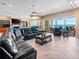 Bright living room featuring a large sectional sofa, wood floors, and ocean views at 3702 El Centro St, St Pete Beach, FL 33706