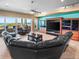 Bright living room featuring a large sectional sofa, wood floors, and ocean views at 3702 El Centro St, St Pete Beach, FL 33706